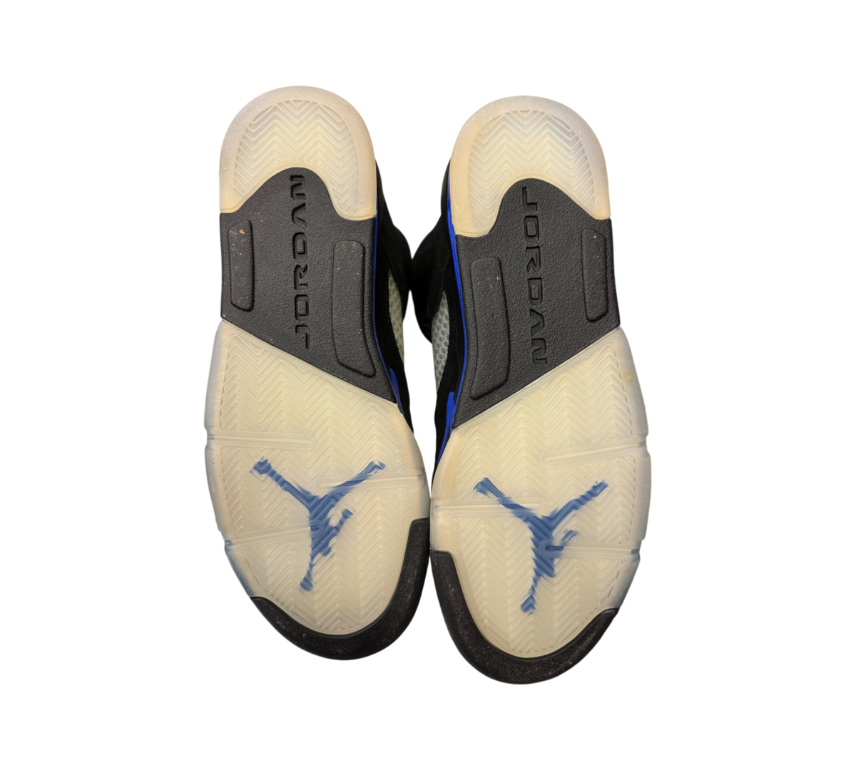 Genesis Boutique Jordan 5 GS Racer Blue sneakers showing the translucent outsoles with blue Jumpman logos