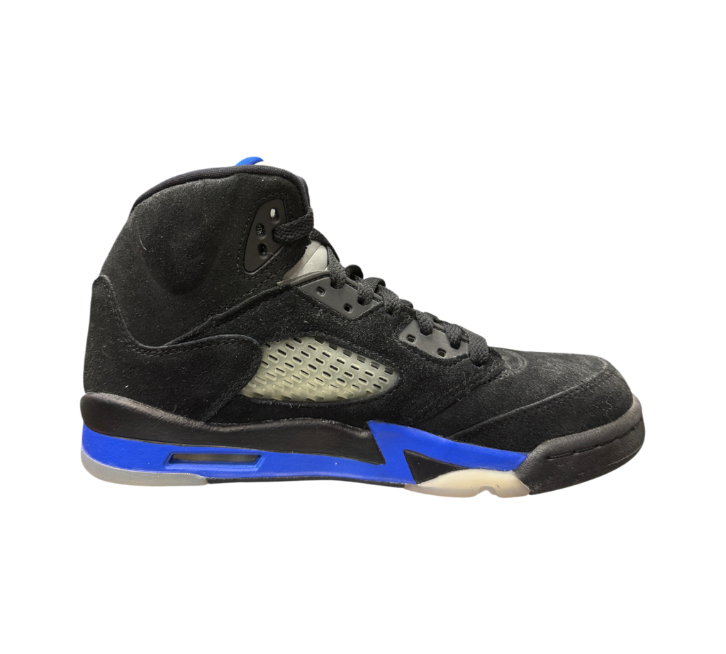 Genesis Boutique Jordan 5 GS Racer Blue sneakers in black suede with vibrant blue midsole accents and side netting.