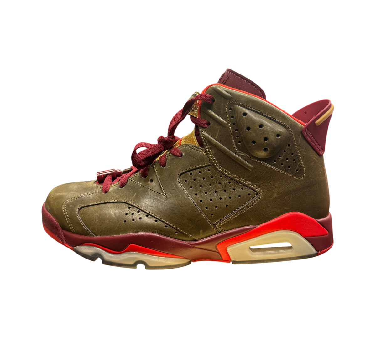 Genesis Boutique Jordan 6 Cigar sneakers in raw umber and team red with gold accents on a display box