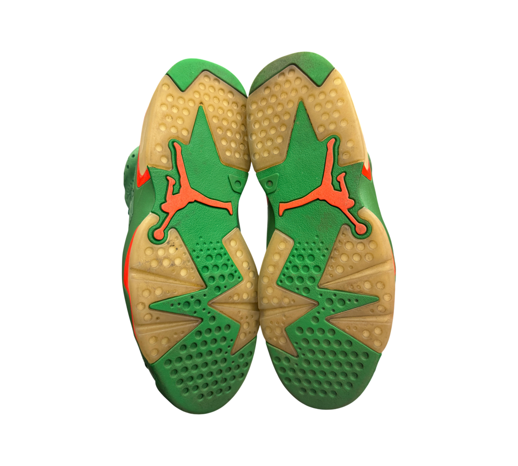 Genesis Boutique used Jordan 6 Gatorade Green sneakers showing the yellowed outsoles with orange Jumpman branding.