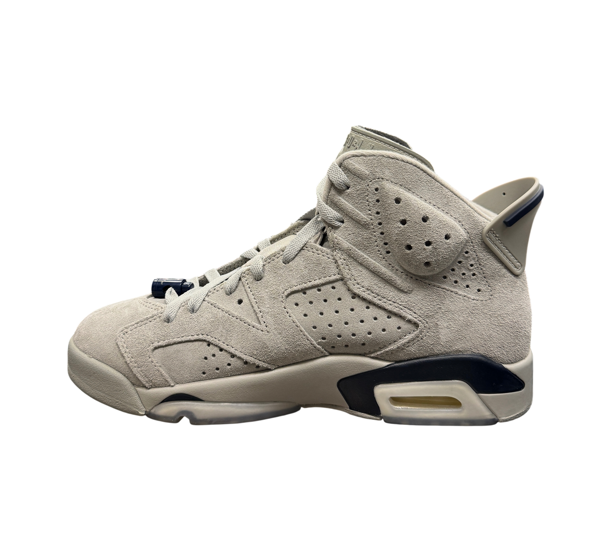Genesis Boutique Jordan 6 Georgetown sneakers in grey suede with navy blue accents displayed on a glass shelf