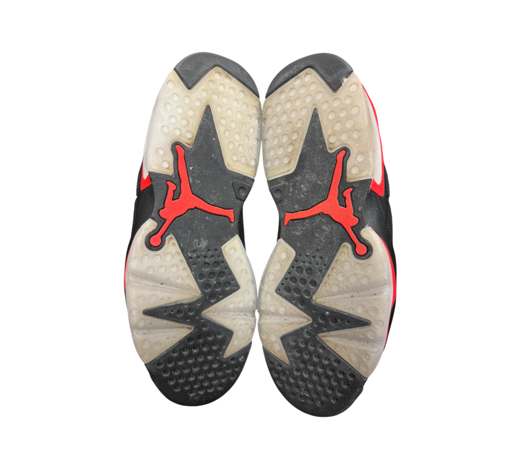 Genesis Boutique Jordan 6 Infrared 2018 sneakers showing the black and translucent outsoles with red Jumpman logos