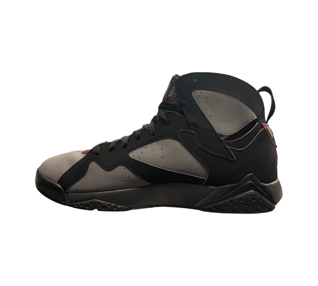 Genesis Boutique Jordan 7 Bordeaux sneakers in black and grey nubuck leather, side profile view on a glass display.
