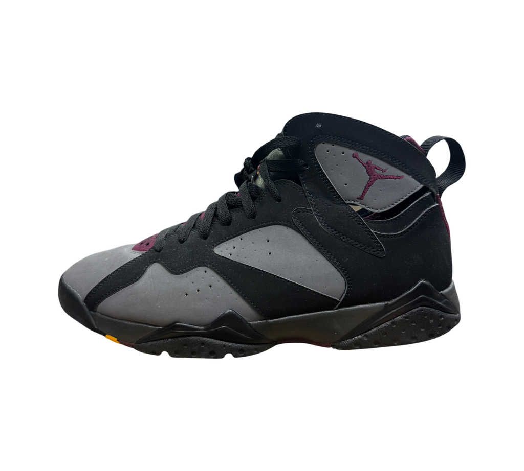 Genesis Boutique used Jordan 7 Bordeaux sneakers in black and grey nubuck with purple accents on a store display box