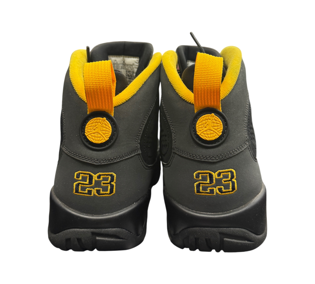 Genesis Boutique Jordan 9 Charcoal sneakers featuring black nubuck uppers with yellow heel tabs and 23 embroidery