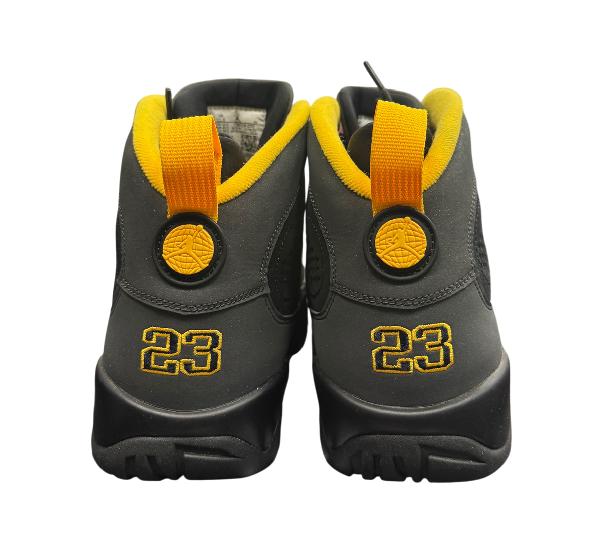 Genesis Boutique Jordan 9 Charcoal sneakers featuring black nubuck uppers with yellow heel tabs and 23 embroidery