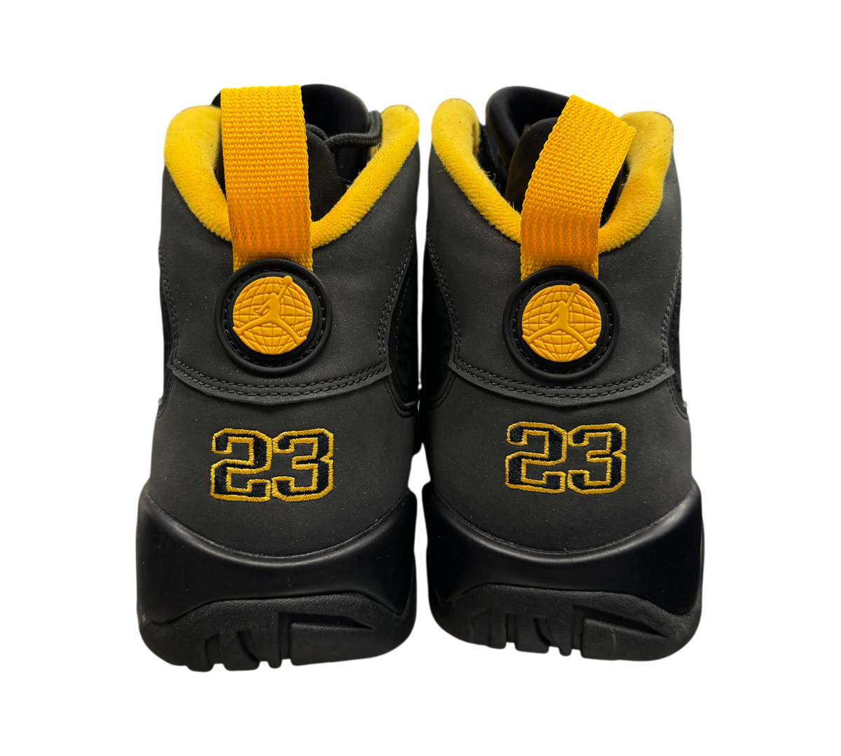 Genesis Boutique Jordan 9 Charcoal sneakers showing the black heel with yellow pull tabs and embroidered 23 logo