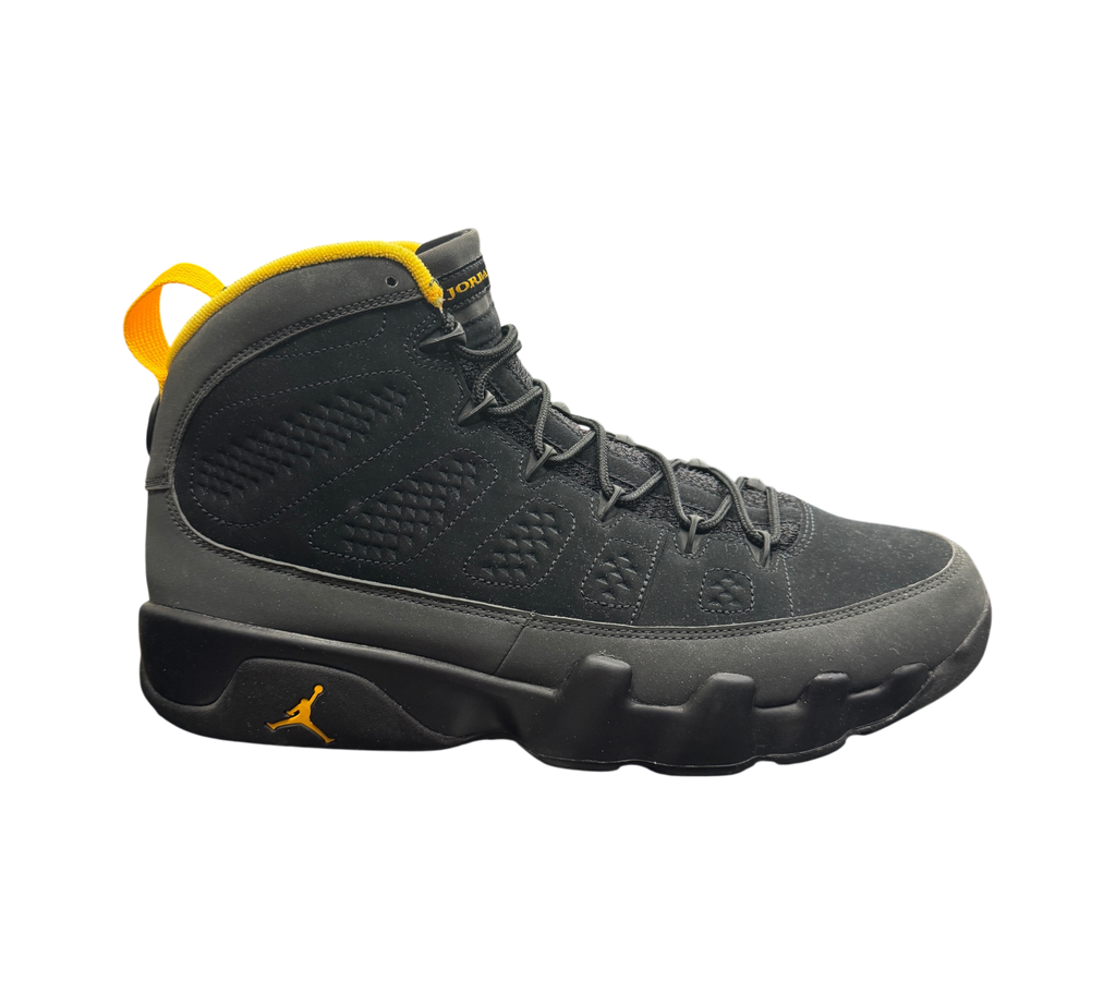 Genesis Boutique Jordan 9 Charcoal sneakers in black nubuck with yellow accents on a branded shoebox
