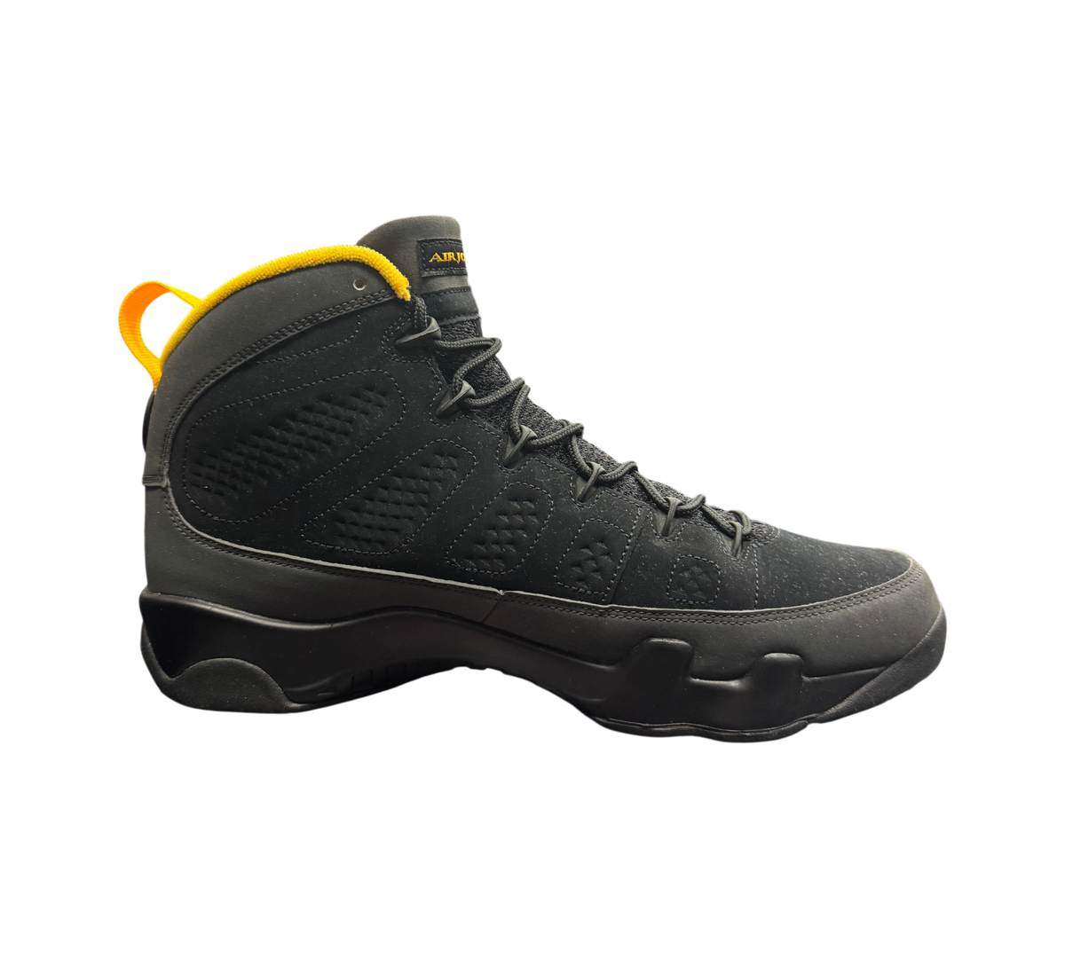 Genesis Boutique Jordan 9 Charcoal high-top sneakers in black with yellow accents on a branded shoebox