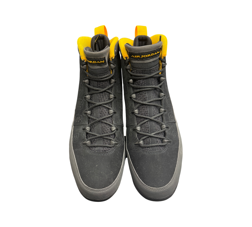 Genesis Boutique Jordan 9 Charcoal sneakers in black nubuck with vibrant yellow collar lining and heel pull tab