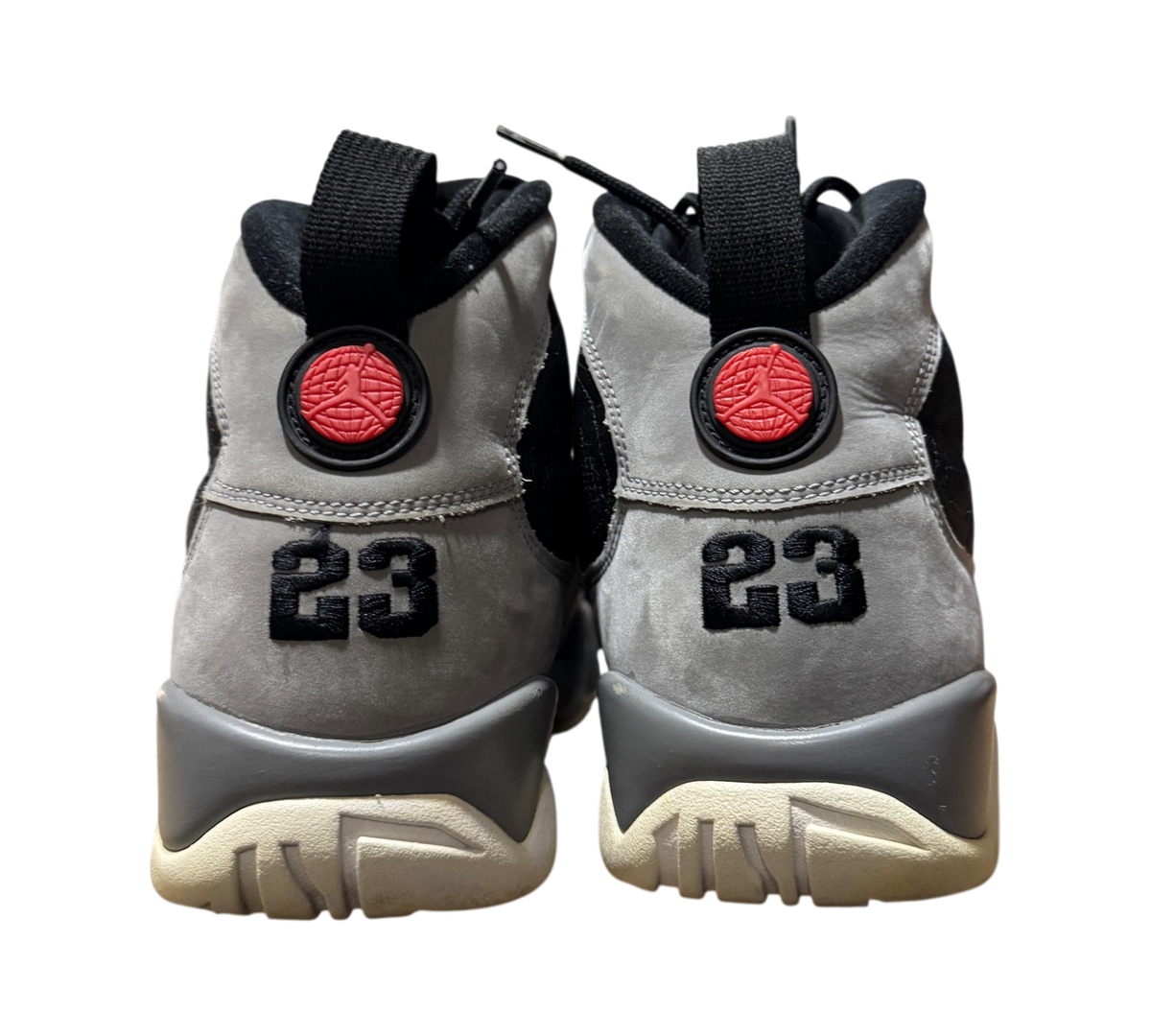 Genesis Boutique Jordan 9 Particle Grey sneakers showing the grey suede heel, black 23 embroidery, and red logo detail