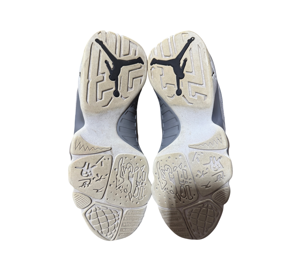 Genesis Boutique used Jordan 9 Particle Grey sneakers showing the worn outsoles with Jumpman logo branding