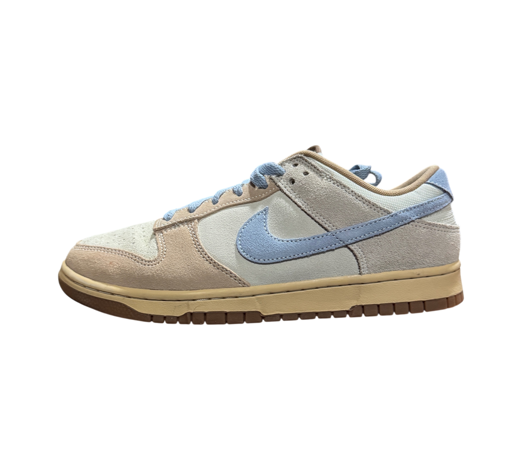 Genesis Boutique Nike Dunk Low Sanddrift Light Armory Blue sneakers featuring suede overlays and a gum rubber sole.