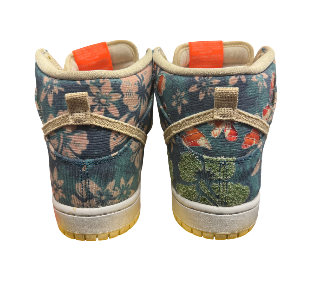 Genesis Boutique used Nike SB Dunk High Hawaii sneakers featuring a floral print with torn patches on the right shoe