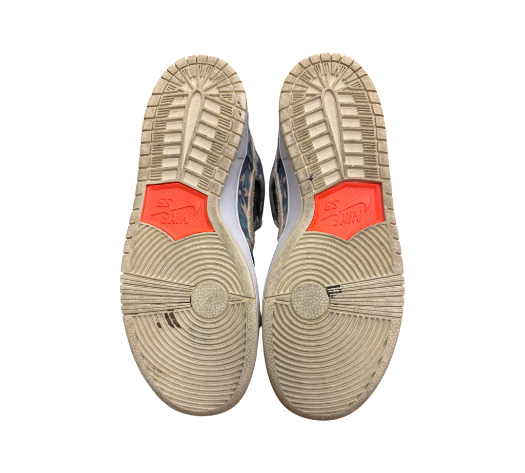 Genesis Boutique used Nike SB Dunk High Hawaii sneakers showing the worn rubber outsoles with orange Nike SB branding.