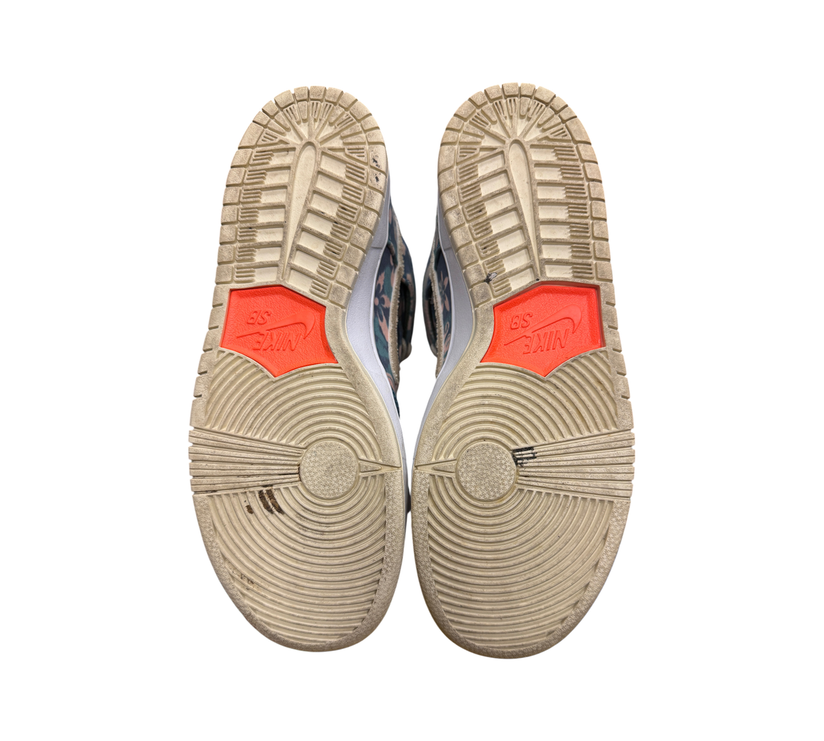Genesis Boutique used Nike SB Dunk High Hawaii sneakers showing the worn rubber outsoles with orange Nike SB branding.