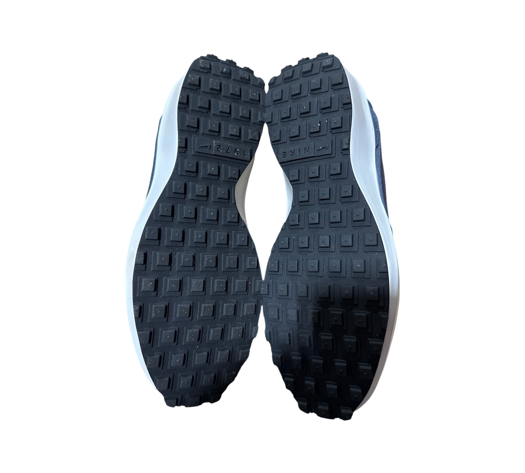 Genesis Boutique used Nike Waffle Debut SE sneakers showing the black rubber waffle tread outsoles