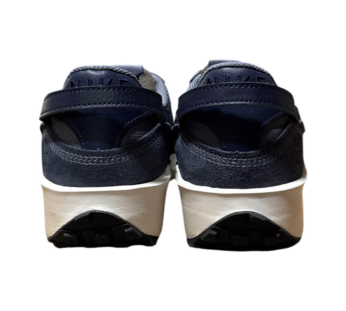 Genesis Boutique Nike Waffle Debut SE sneakers in light carbon and obsidian blue, rear view showing white midsoles.