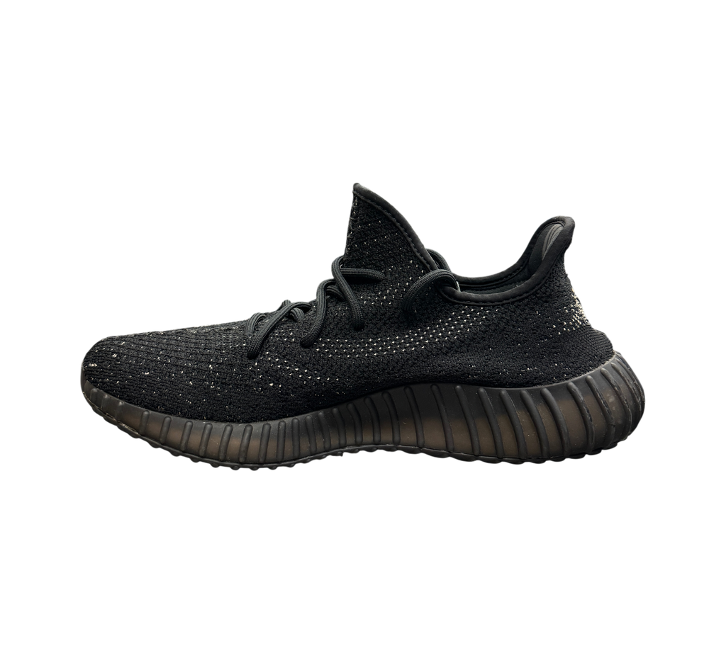 Genesis Boutique Yeezy 350 Oreo sneakers in black Primeknit with a side stripe, side profile view.