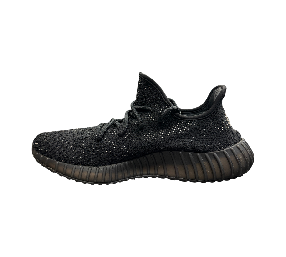 Genesis Boutique Yeezy 350 Oreo sneakers in black Primeknit with a side stripe, side profile view.