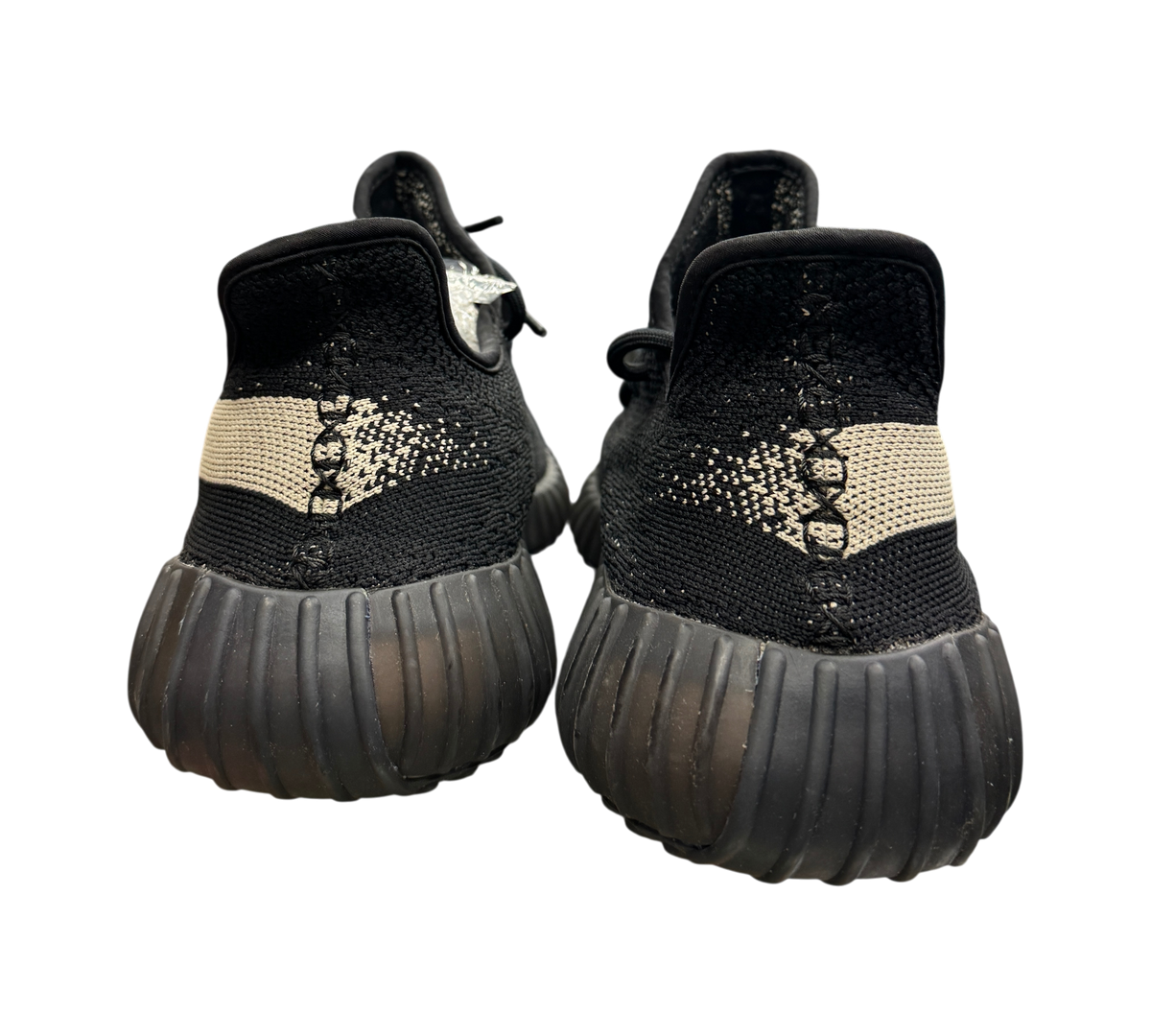 Genesis Boutique used Yeezy 350 Oreo sneakers in black and white, rear view showing textured soles and heel detail.