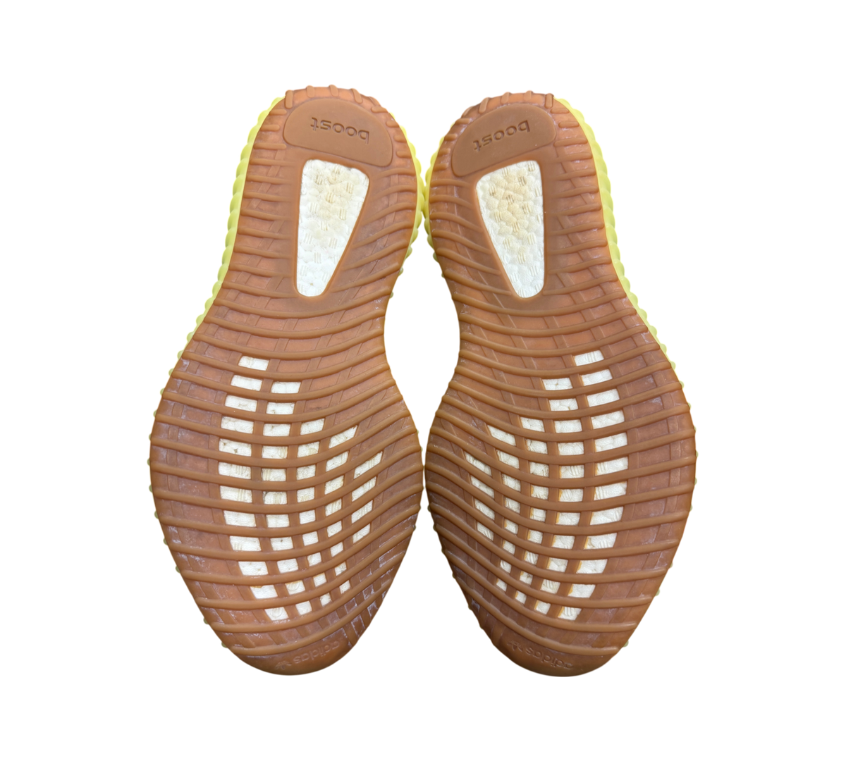 Genesis Boutique Yeezy 350 Semi Frozen Yellow sneakers showing the brown rubber outsoles and white boost cushioning