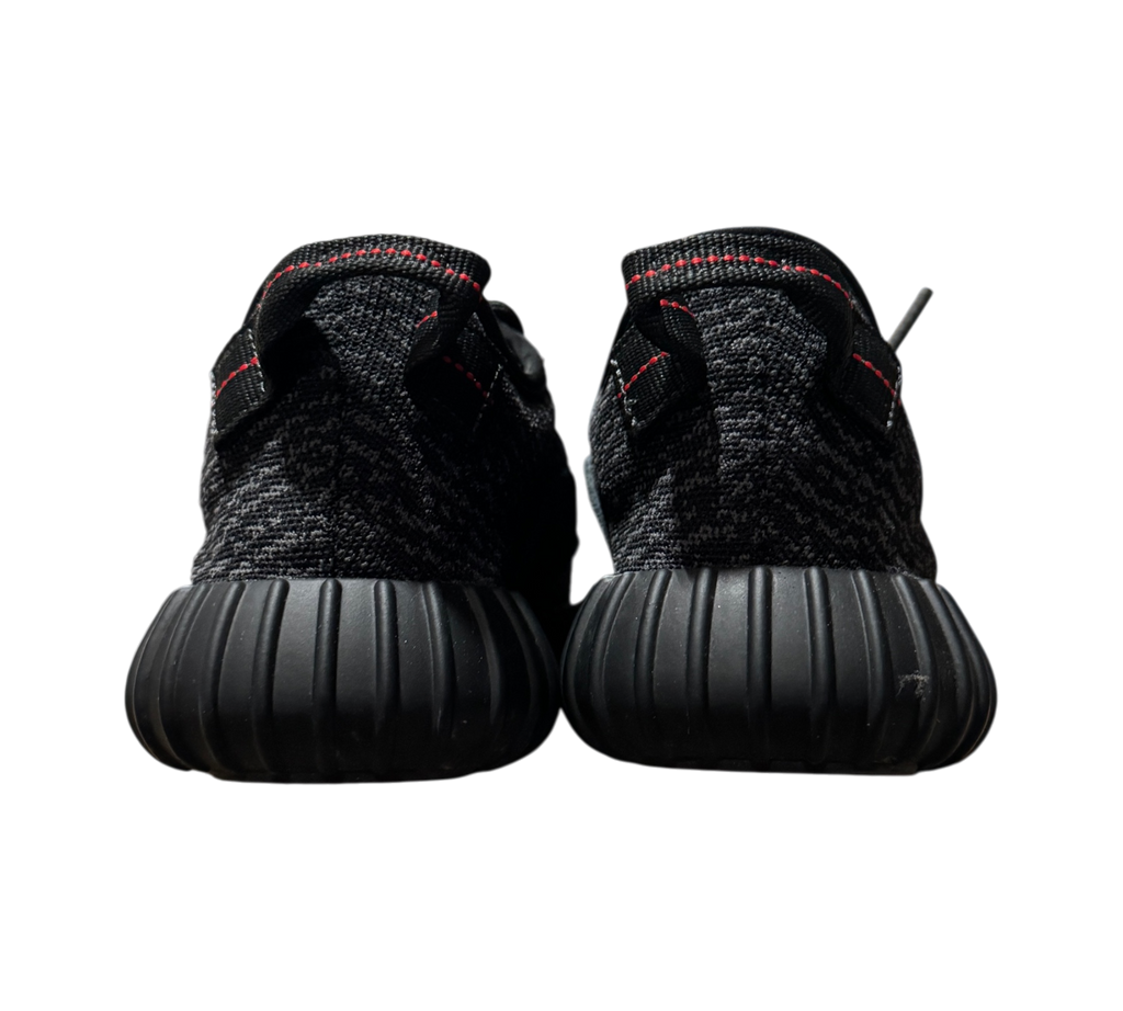Genesis Boutique Yeezy 350 Pirate Black 2023 sneakers showing the black textured heel and red stitching detail