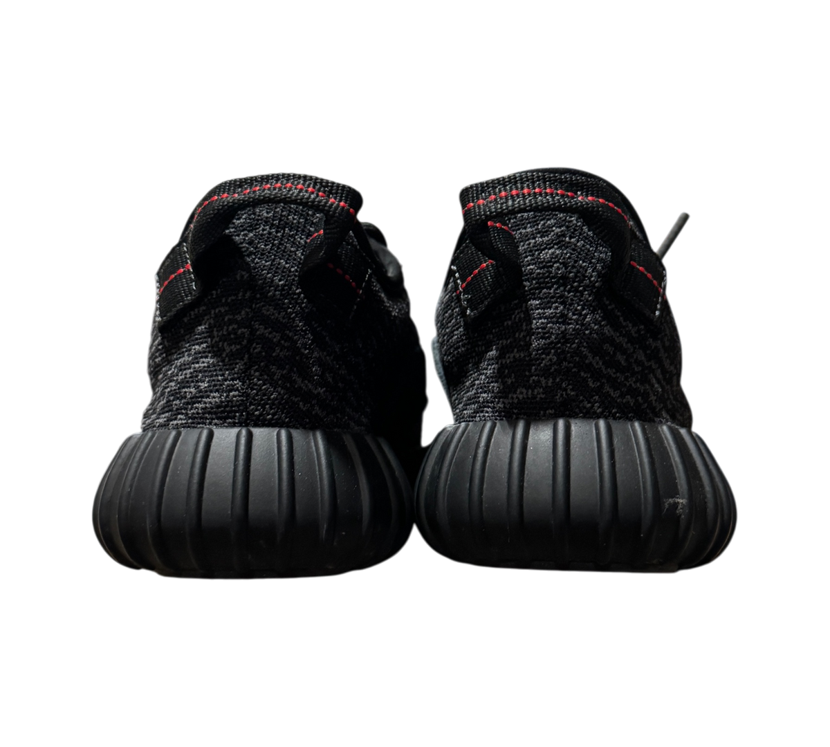 Genesis Boutique Yeezy 350 Pirate Black 2023 sneakers showing the black textured heel and red stitching detail