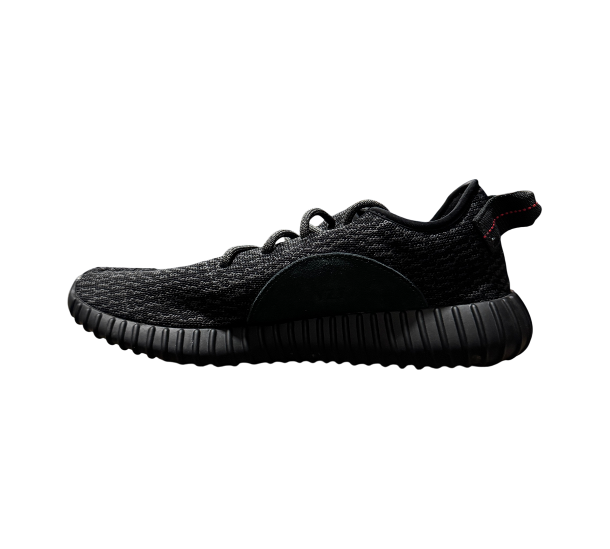 Genesis Boutique Yeezy 350 Pirate Black 2023 sneaker in black Primeknit with red heel tab stitching, side profile view