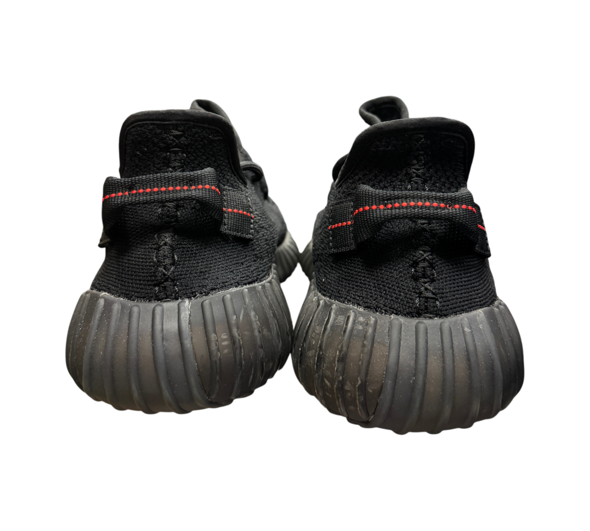Genesis Boutique Yeezy 350 V2 Bred sneakers in black with red stitching detail on the heel tab, rear view.