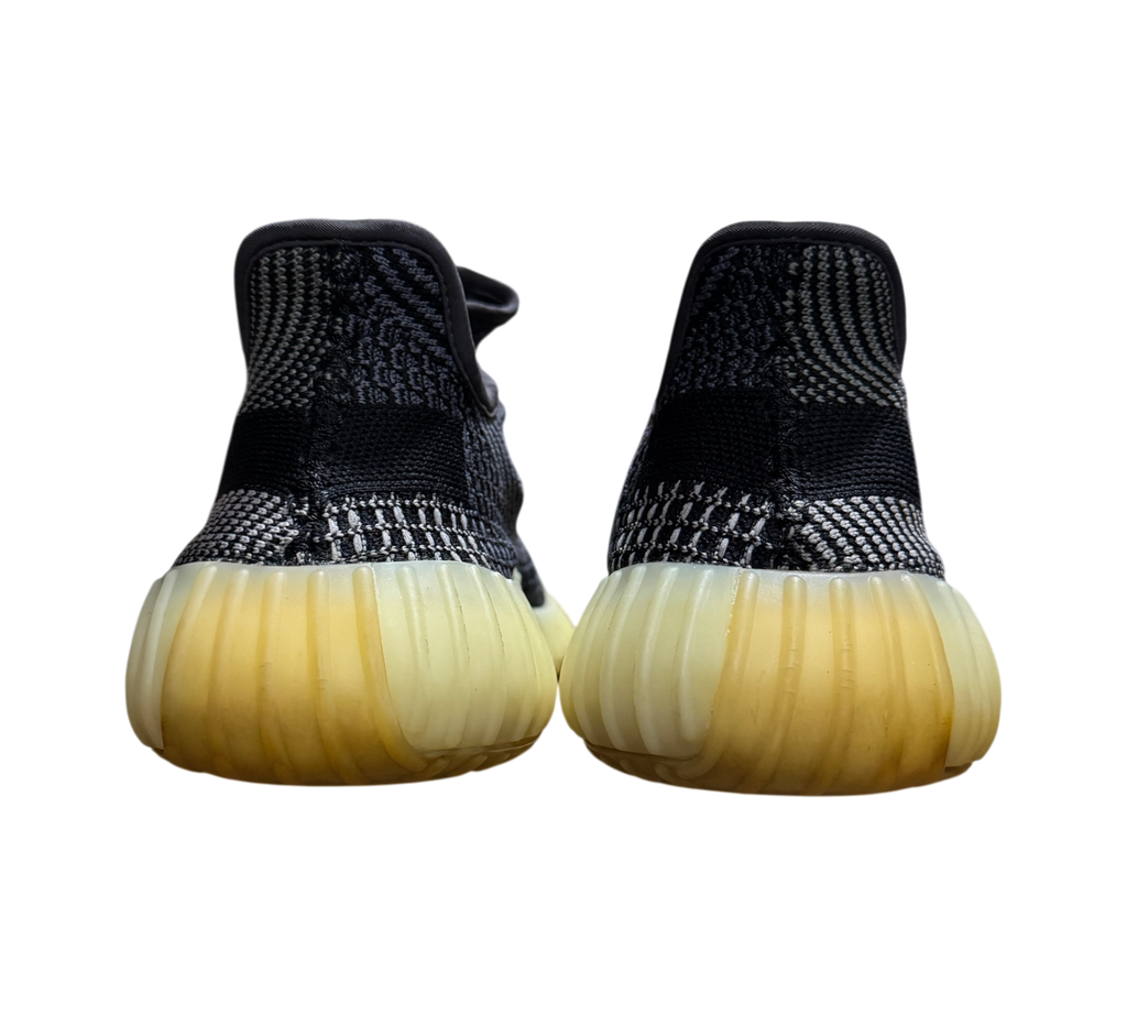 Genesis Boutique Yeezy 350 V2 Carbon sneakers showing the back heel view with black patterned knit and yellowed soles