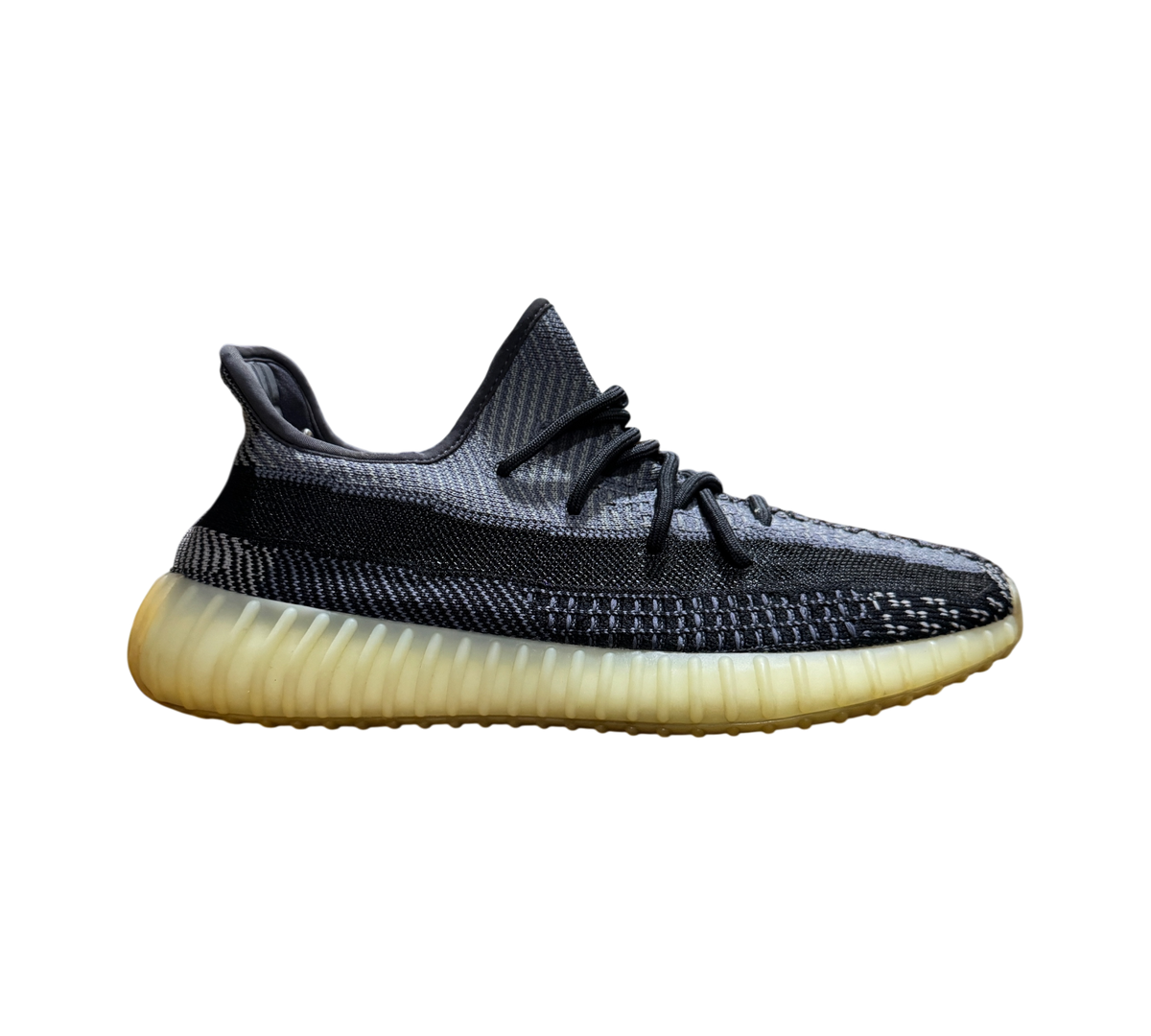Genesis Boutique used Yeezy 350 V2 Carbon sneakers featuring a grey and black knit upper and yellowed rubber sole.