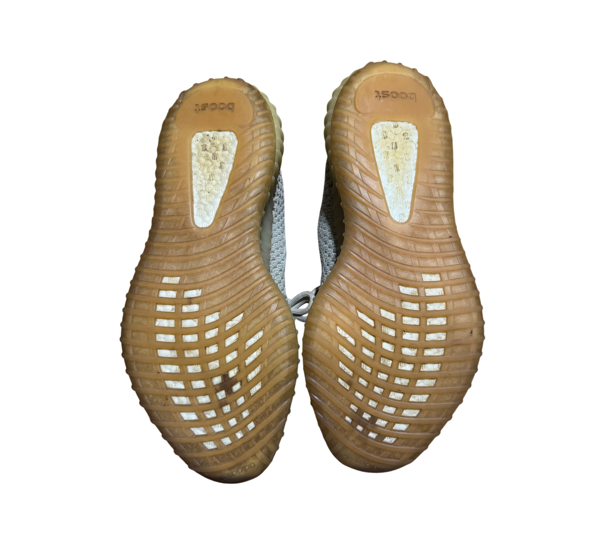 Genesis Boutique used Yeezy 350 V2 Citrin sneakers showing the worn gum rubber outsoles and Boost cushioning