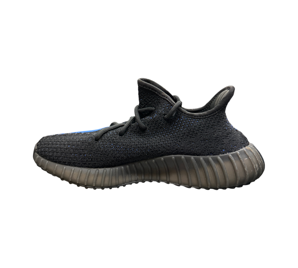 Genesis Boutique Yeezy 350 V2 Dazzling Blue sneaker in black knit with blue stripe detail on a glass display table
