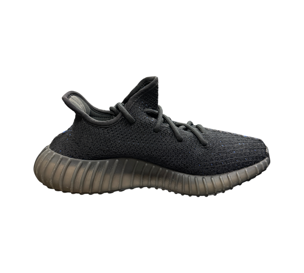 Genesis Boutique Yeezy 350 V2 Dazzling Blue sneaker in black knit with blue stripe detail on a glass display table