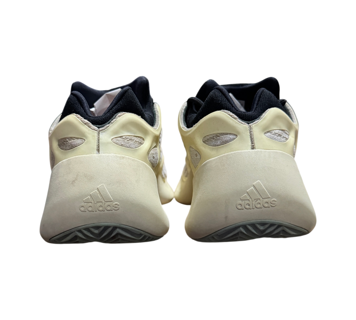 Genesis Boutique used Yeezy 700 Azael sneakers showing the off-white heel and black collar from a rear perspective.