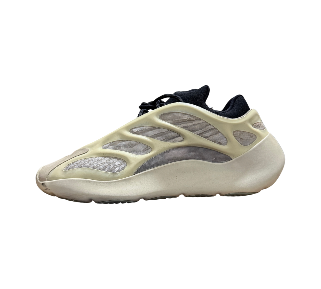 Genesis Boutique used Yeezy 700 Azael sneakers in off-white with black accents, side profile view in warehouse setting