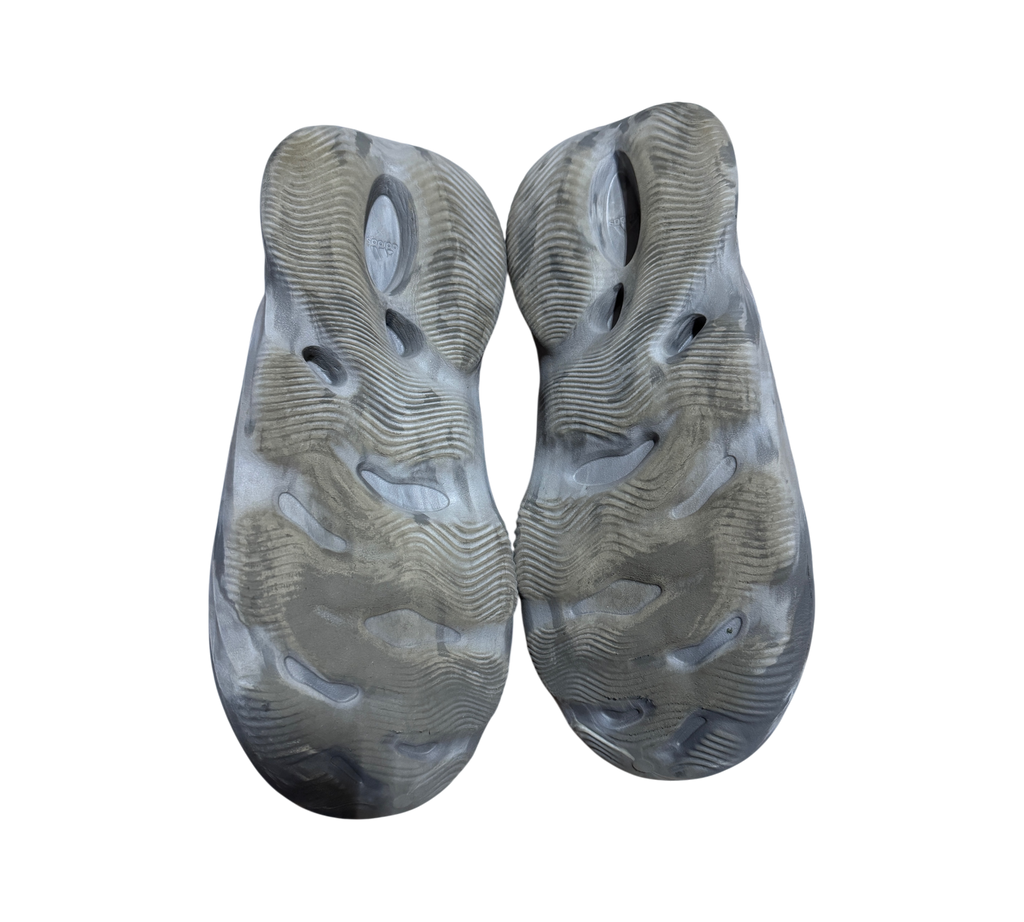 Genesis Boutique used Yeezy Foam Runner MX Granite slip-on shoes showing the textured grey marbled rubber outsoles