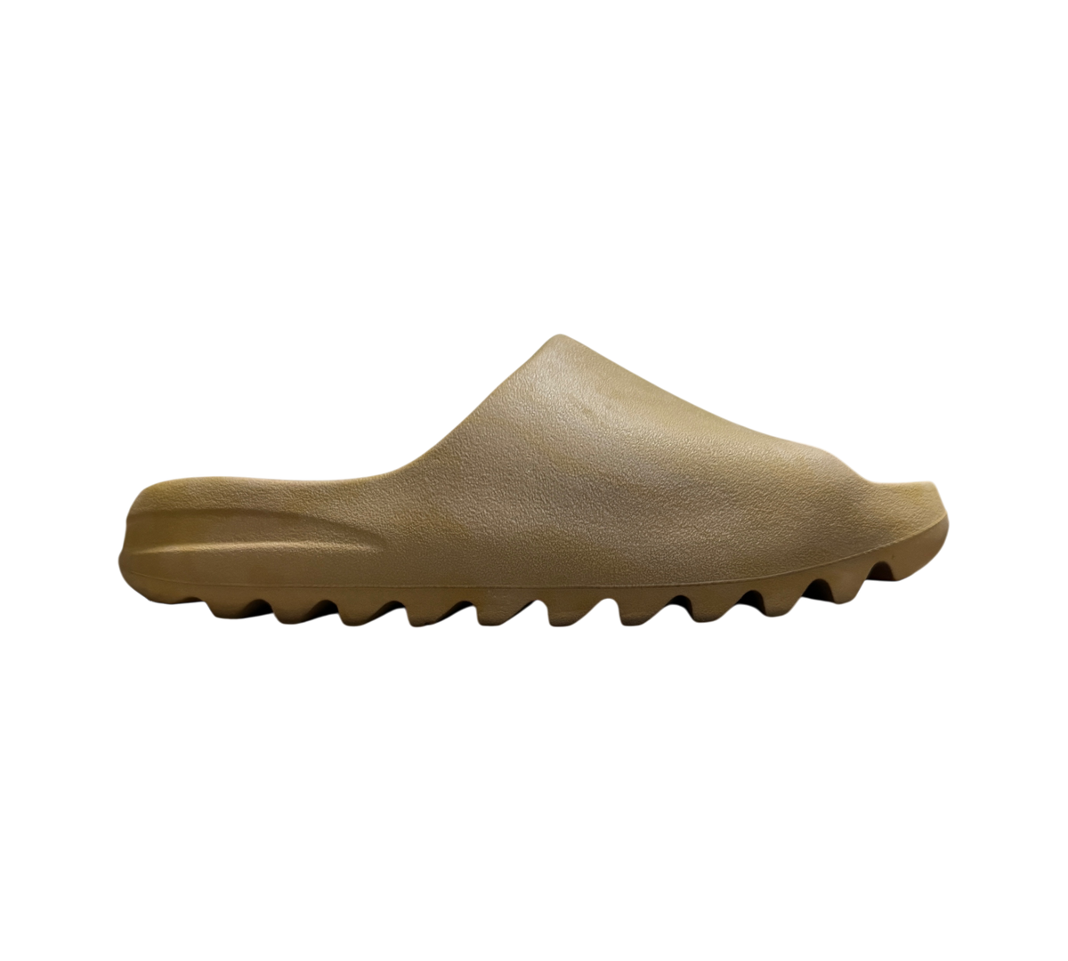 Genesis Boutique Yeezy Slide Ochre in a tan foam material with a signature serrated outsole, side profile view.