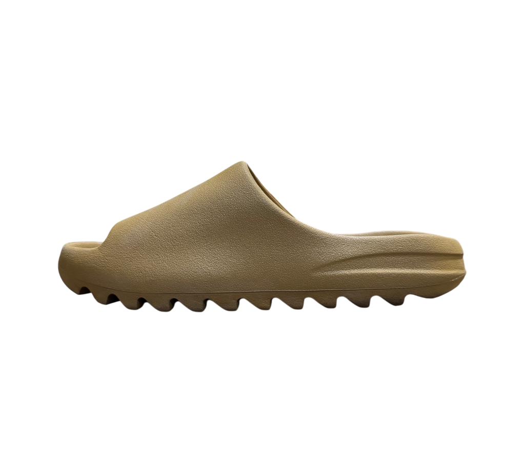 Genesis Boutique Yeezy Slide Ochre in a tan foam material with a signature serrated sole, side profile view.