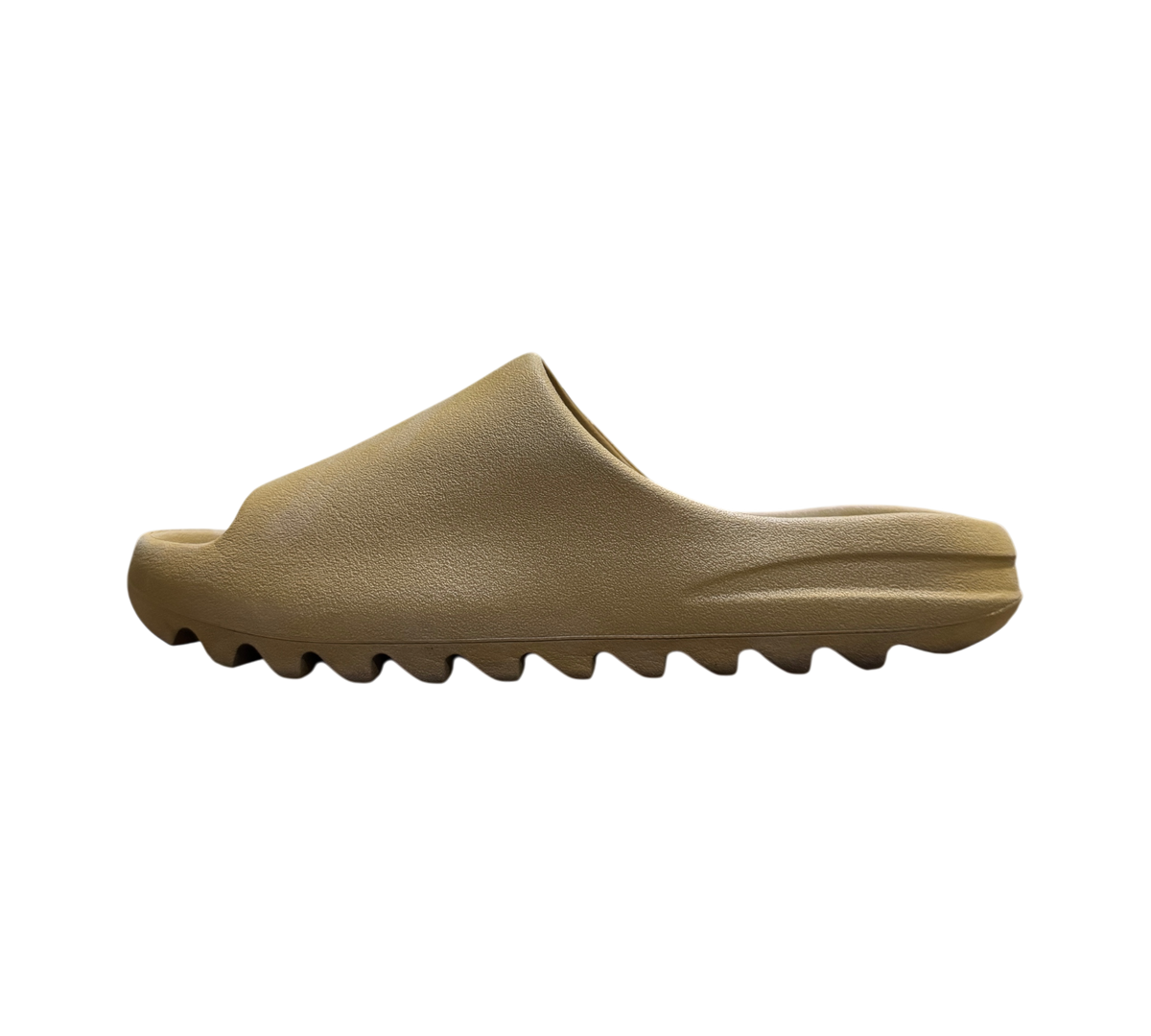Genesis Boutique Yeezy Slide Ochre in a tan foam material with a signature serrated sole, side profile view.